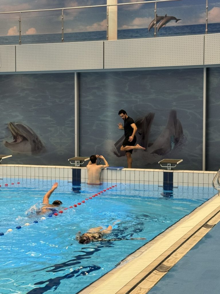 win and swim coach showing exercise